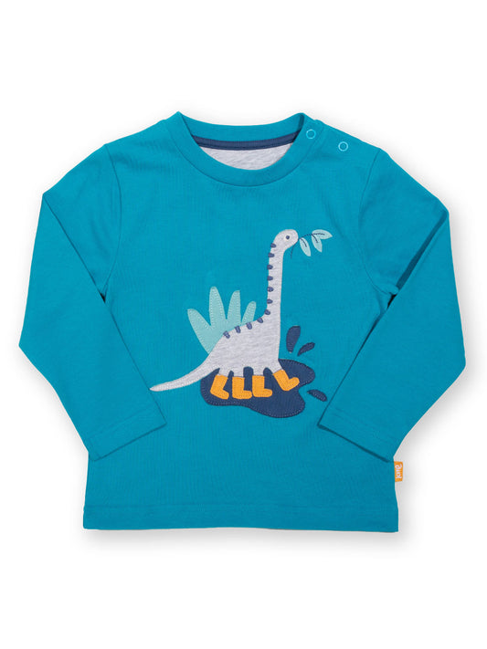 Polera Dino Feliz de algodón orgánico, color calipso con aplique de dinosaurio y manga larga.