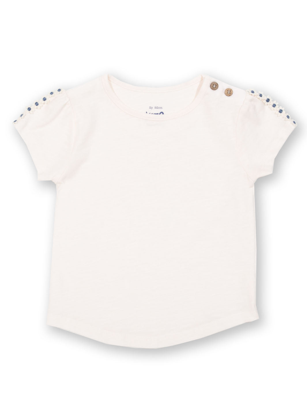 Polera Margaritas de algodón orgánico, color blanco crema con ribete de margaritas y manga corta.
