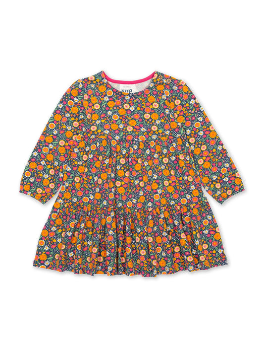 Vestido Flores de Amor de algodón orgánico, con estampado floral naranja, manga larga y falda escalonada.