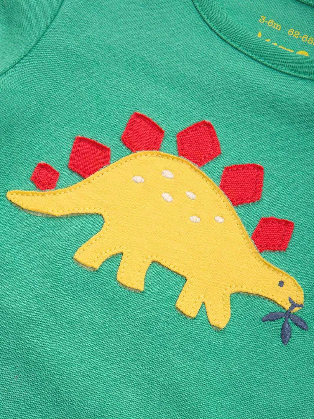 Detalle de aplicación dinosaurio en body día de dinosaurios de algodón orgánico.