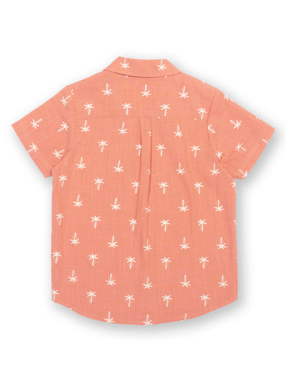 Vista trasera de camisa infantil terracota con diseño de palmeras en algodón orgánico