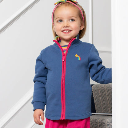 Niña usando el Polerón Detalles de Amor de algodón orgánico, combinado con calzas para un look abrigador y encantador.