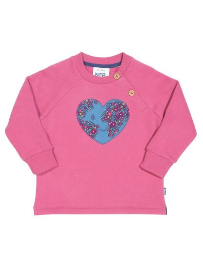 Polerón Planeta Amor de algodón orgánico, rosa ruibarbo con aplique de planeta en forma de corazón y estampado de flores.