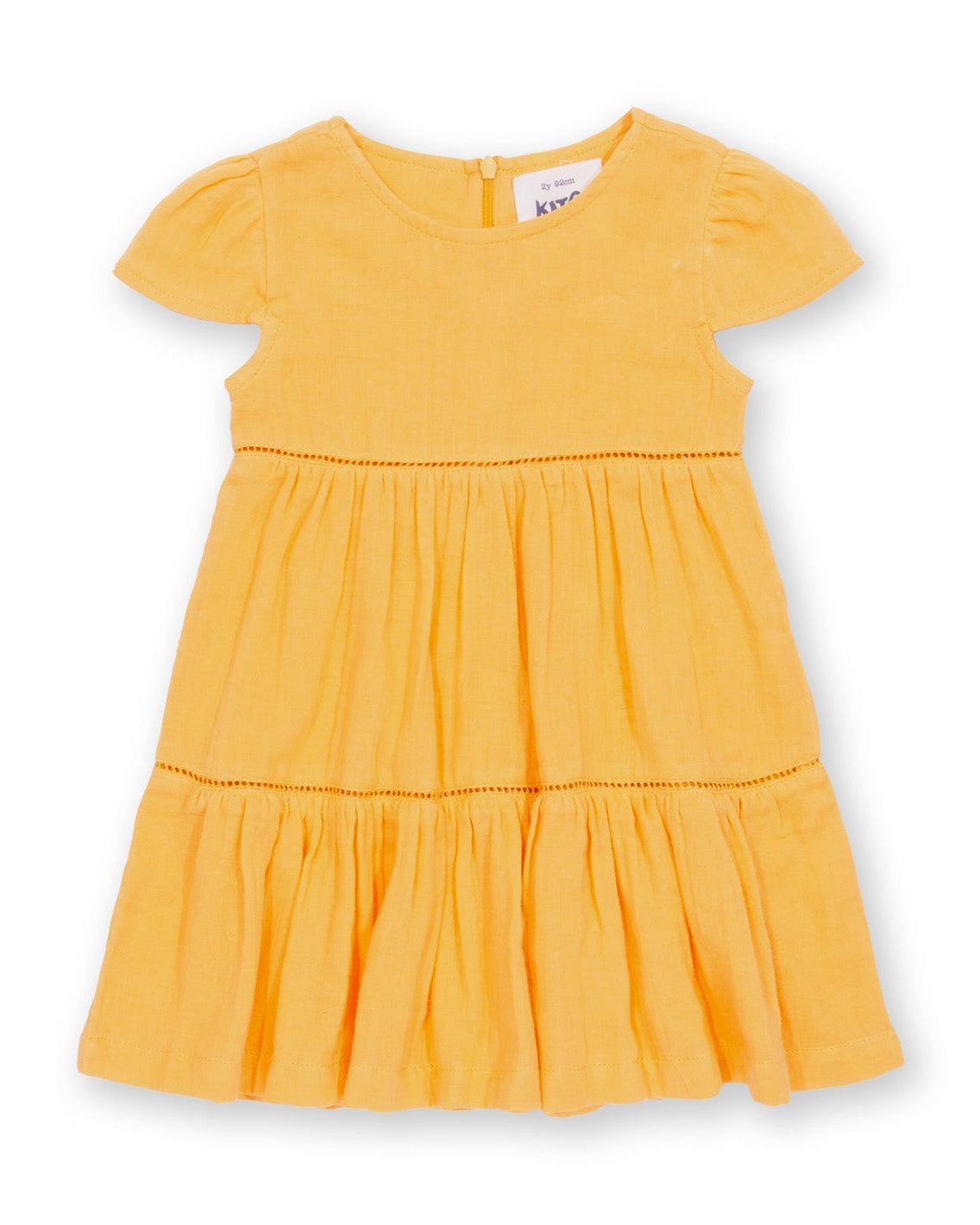 Vestido Atardecer de algodón orgánico, amarillo cálido con falda escalonada y mangas fruncidas.